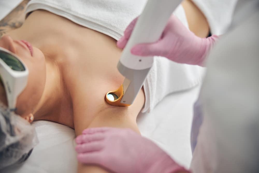 Close up of woman undergoing laser hair removal on her under arm.